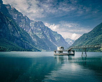 Scenic view of lake and mountains against sky