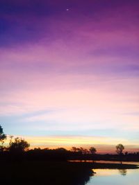 Scenic view of lake against romantic sky at sunset