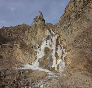 Rock formation on land against sky