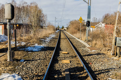Railroad tracks amidst trees against sky