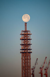 Low angle view of communications tower against clear sky