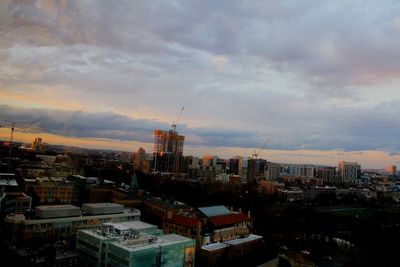 View of cityscape against cloudy sky