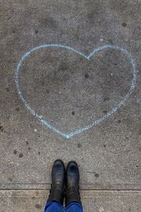 Low section of person standing on heart shape