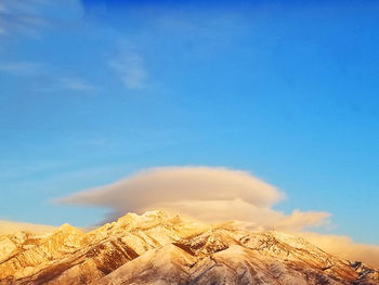 Low angle view of snowcapped mountain against sky