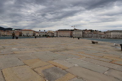 Buildings in city against cloudy sky