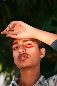 Close-up portrait of serious man with face paint