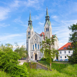 Low angle view of trees and buildings against sky