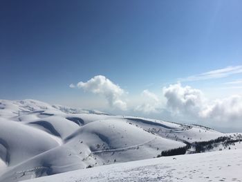 Scenic view of snowcapped mountains against sky