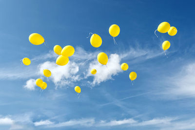 Low angle view of balloons against sky