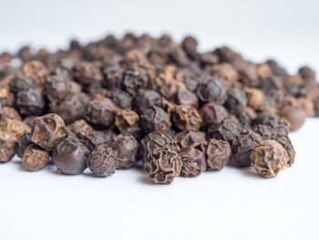 Close-up of roasted coffee beans against white background