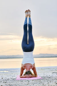 Woman mediating at beach