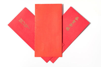 Close-up of red envelope on white background