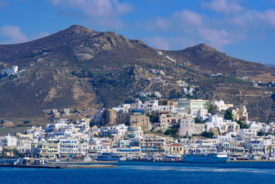 Scenic view of sea by city against sky