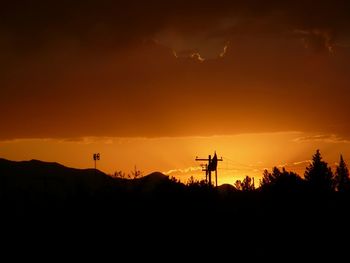 Silhouette of landscape against sunset sky