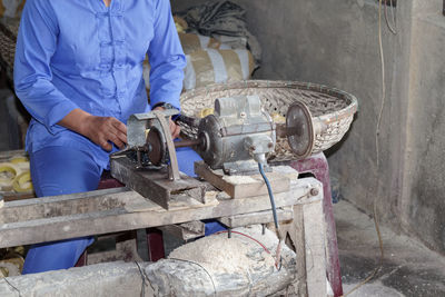 Woman working on machinery in factory