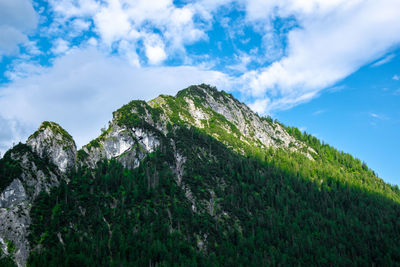 Low angle view of rocky mountain against sky