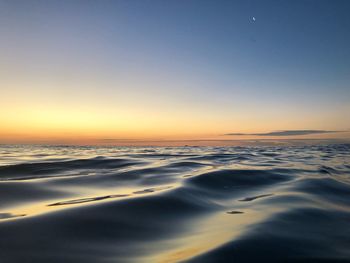 Scenic view of sea against clear sky during sunset