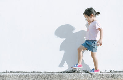 Full length of girl playing against clear sky