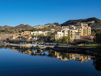 Reflection of buildings on lake against sky