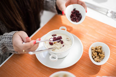 Midsection of woman having breakfast