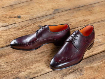 High angle view of shoes on wooden floor