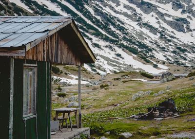 Cottage by snowcapped mountains