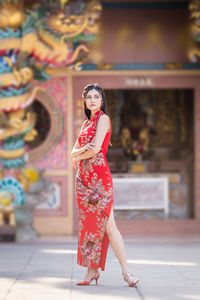 Portrait of young woman standing outdoors