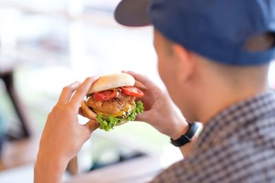 Close-up of man eating burger