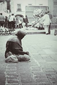 Rear view of men sitting on street