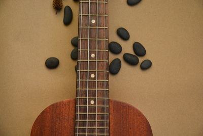 Close-up of guitar and pebbles on table