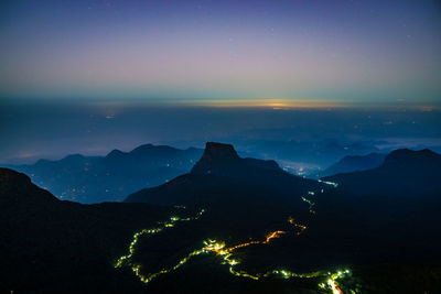 Scenic view of silhouette mountains against sky at night