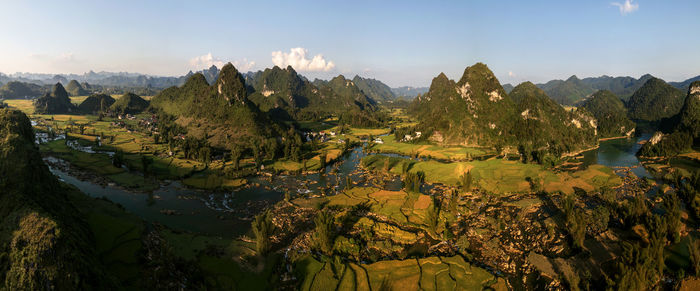 Panoramic view of trees and mountains against sky