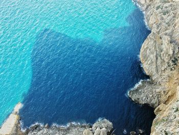 Directly above shot of rock formation and sea