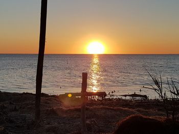 Scenic view of sea against orange sky