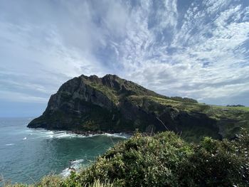 Scenic view of sea and mountains against sky