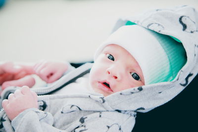 Portrait of baby lying on bed