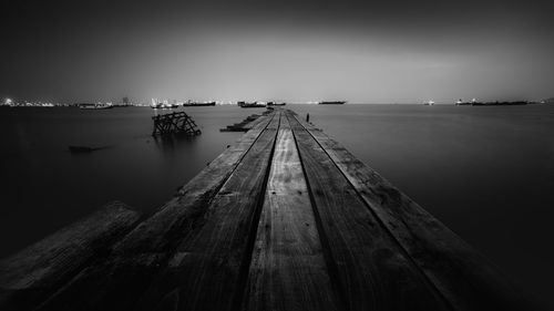 Jetty in sea against sky