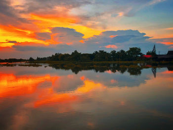 Scenic view of lake against orange sky