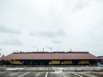 Houses by building against sky