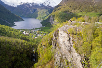 High angle view of lake amidst trees and mountains
