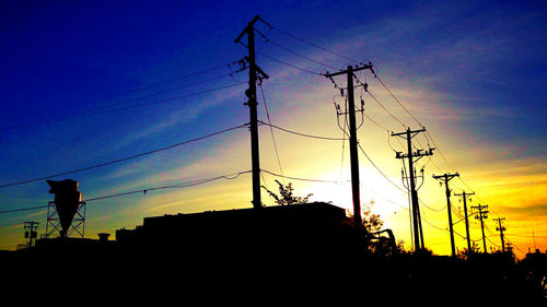 Low angle view of electricity pylon against sky