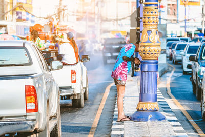 Full length of man photographing on street