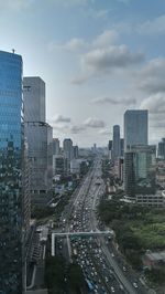 High angle view of street amidst buildings in city against sky