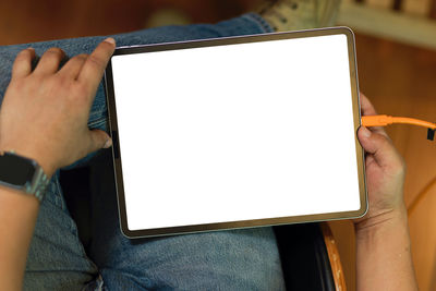Midsection of man using mobile phone