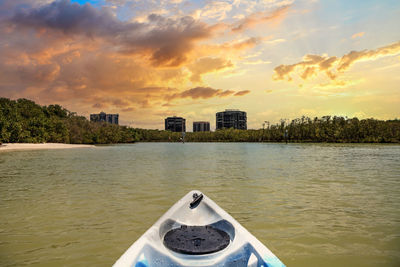 Scenic view of river against sky at sunset