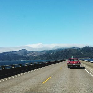 Car on bridge against sky