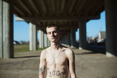 Portrait of shirtless young man outdoors