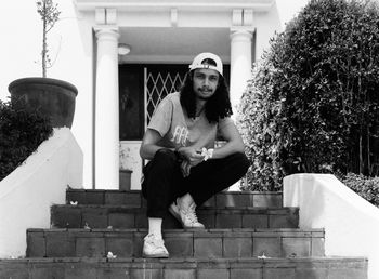 Portrait of young man sitting on steps