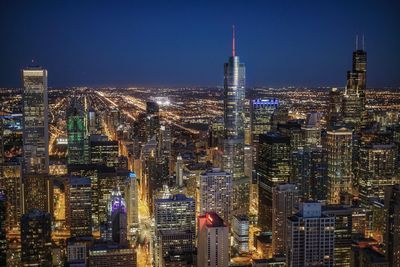 Aerial view of illuminated city buildings at night