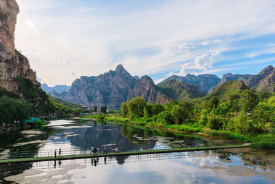 Scenic view of lake and mountains against sky